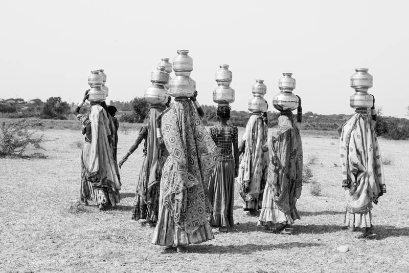 Women and Drinking Water Challenges - rural women carrying headloads of drinking water from a distant ‘sweet’ water pond in salinity-affected Kutch district, Gujarat